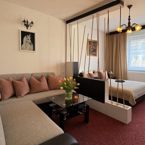 a living room with a couch and a bed at Penzión u Veroniky in Ždiar