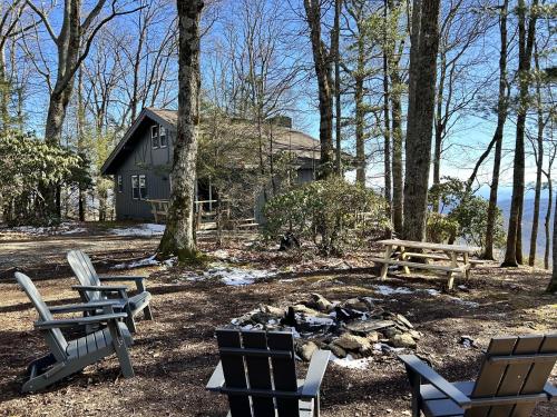 a group of chairs and a fire pit in front of a house at Blue View Chalet in Blowing Rock