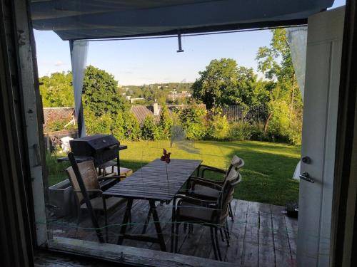a table and chairs on a patio with a view at Hilltop view - 2 bedroom house with garden bbq - private parking - 12min to Uzupis anytime in Vilnius