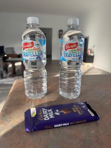 two bottles of water and a bag of water bottleveltveltveltveltveltvelt at Farm Stay, Feed Sheep & Relax in Diggers Rest
