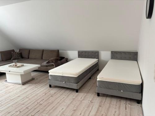 a living room with two beds and a couch at Haus Anna O in Westoverledingen