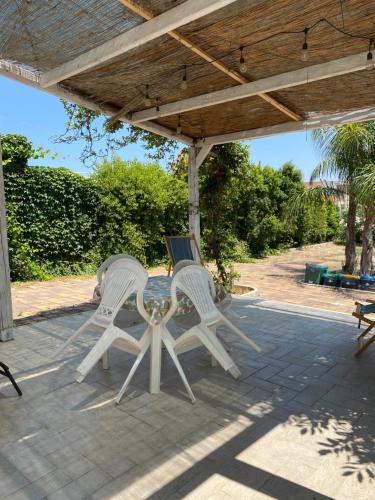 two white chairs sitting on a patio at Il Fenicottero in San Pietro in Bevagna