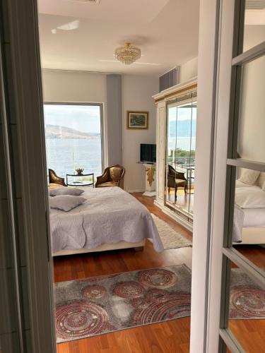a bedroom with a bed and a view of the ocean at Shimmer & Shine in Baška