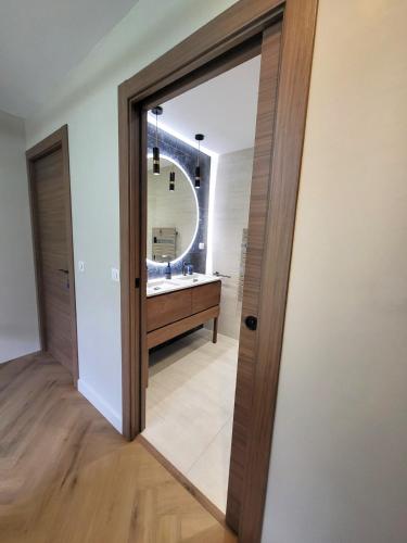 a bathroom with a mirror and a sink at Séjour d'Exception - Villa 4 Suites Vue Cascade in Gavarnie