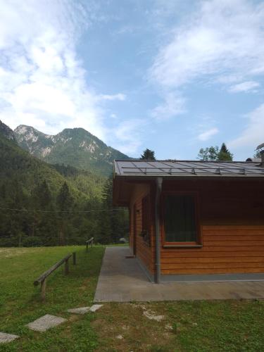 a log cabin with mountains in the background at Orsera in Cesiomaggiore