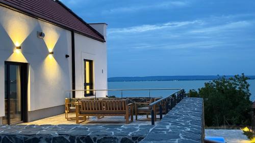 a balcony of a house with benches on it at Casa Canem in Badacsonytomaj