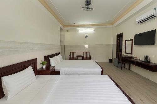 Katil atau katil-katil dalam bilik di Spring Hung Anh Hotel - Sân Bay TSN