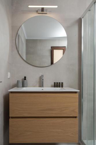 a bathroom with a sink and a mirror at Fyllianos Apartments in Plátanos