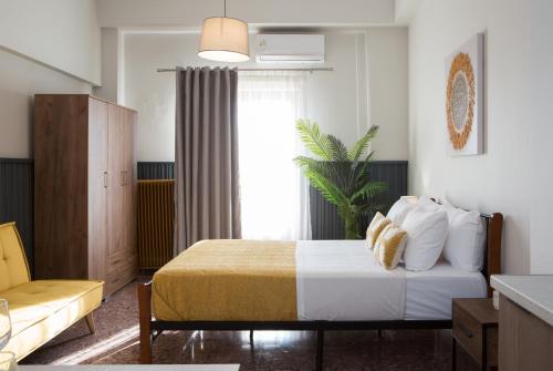 a hotel room with a bed and a window at Fyllianos Apartments in Plátanos