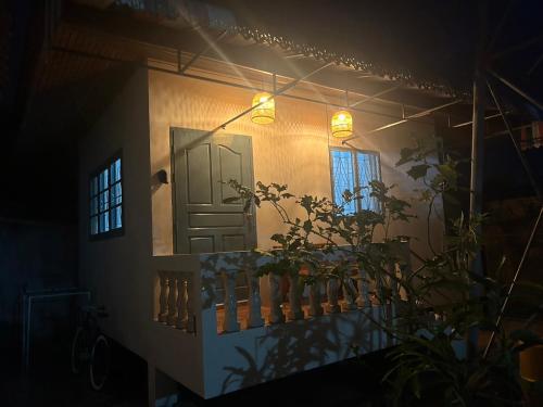 a house with a door and a balcony at night at Cozy House blue in Fisherman's village in Bophut 