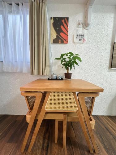 a wooden table with a potted plant on top of it at Katsu hotel #2 in Osaka