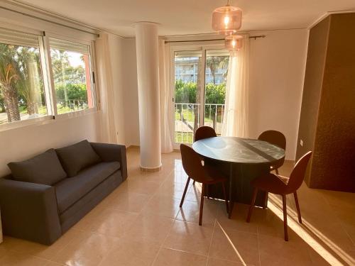 a living room with a couch and a table and chairs at Duplex Deluxe in Torreblanca