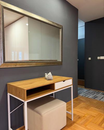 a dressing table with a mirror and a stool at Apartment CityHeart in Ohrid
