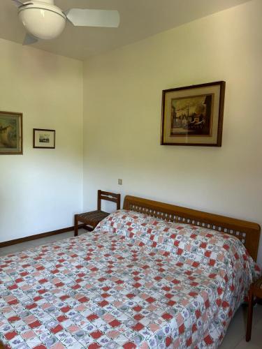 a bedroom with a bed with a quilt on it at Trilocale 250m dal mare in San Vincenzo