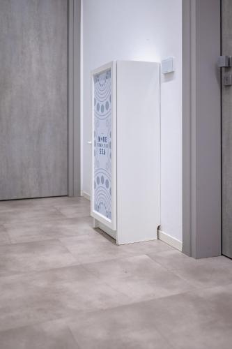 a white refrigerator in an empty room at Superior Beach Aparthotel in Lido di Jesolo