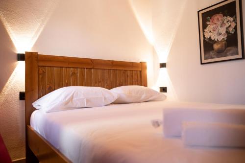 a bedroom with a bed with two pillows at Old Street Villa in Gjirokastër