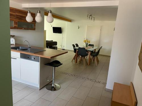 a kitchen and dining room with a table and chairs at Ferienhaus Haus Auenland in Nohfelden