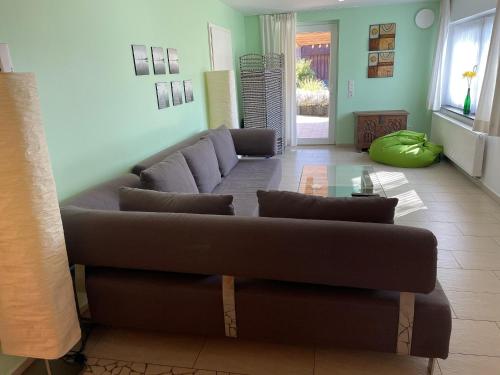 a living room with a couch and a table at Ferienhaus Haus Auenland in Nohfelden