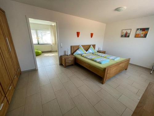 a bedroom with a bed with blue pillows on it at Ferienhaus Haus Auenland in Nohfelden