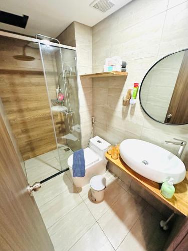 a bathroom with a toilet and a sink and a shower at 303MSNK Luxe Spacious Studio l Balcony in Can Tho