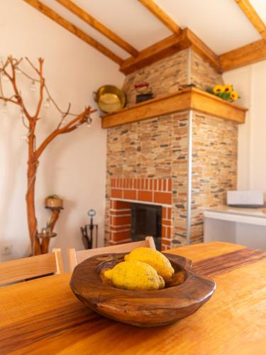 a plate of food on a wooden table with a fireplace at MdM - Monte dos Mestres in São Domingos