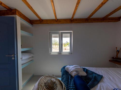 a bedroom with a bed and a window at MdM - Monte dos Mestres in São Domingos