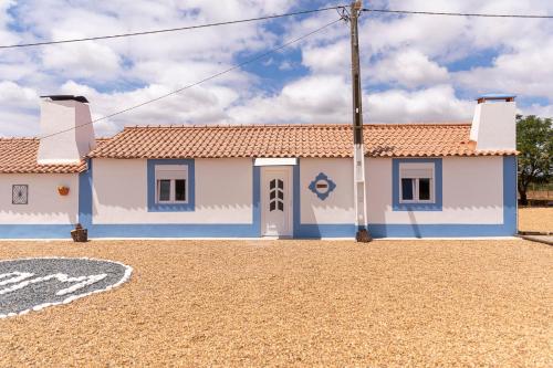 a blue and white house on a gravel road at MdM - Monte dos Mestres in São Domingos