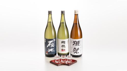 a group of four bottles of wine and glasses at Hotel Sumire ふぐ料理を愉しむ料理宿 in Shimonoseki