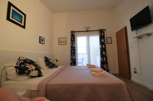 a bedroom with a large bed and a window at Villa Hortus in Neum