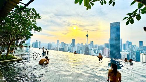 a infinity pool with a city skyline in the background at Axon Residence Near Fehrenheit Bukit Bintang in Kuala Lumpur