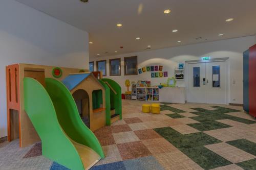a room with a play area with a slide at Aldiana Club Ampflwang in Ampflwang im Hausruckwald