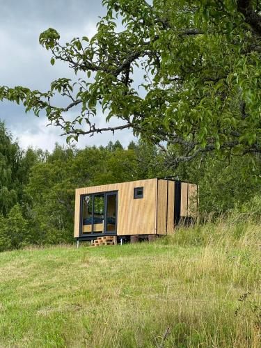 a house sitting on top of a grass field at Jeseníky glamp in Dolní Moravice