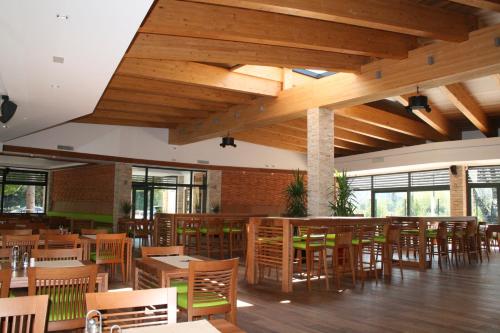 a dining room with wooden tables and chairs at Villas and apartments Oaza in Sarajevo
