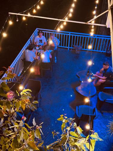 a group of people sitting on a deck at night at Adams Peak Inn in Adams Peak