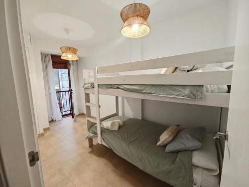a room with two bunk beds and a hallway at Apartamento Portonovo-Baltar in Portonovo