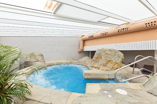 a small swimming pool in a building with a pool at Hotel Best Roquetas in Roquetas de Mar