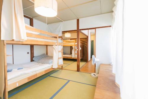 a room with bunk beds in a hostel at Guesthouse RICO in Wakayama