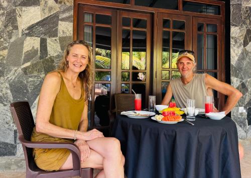 a man and a woman sitting at a table at Village Life Mihinthale in Anuradhapura