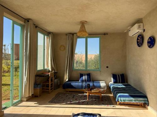 a living room with a couch and a window at Family Village Marrakech in Marrakech