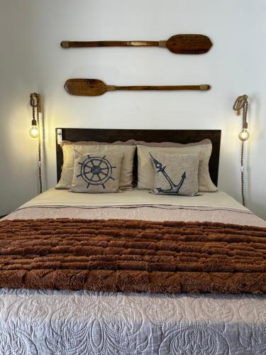a bedroom with a bed with two oars on the wall at Suíte Boqueirão Tati Ortega in Ilha Comprida