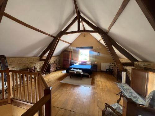 Cette chambre mansardée comprend un lit et un escalier. dans l'établissement La Fleurie, à Marquay