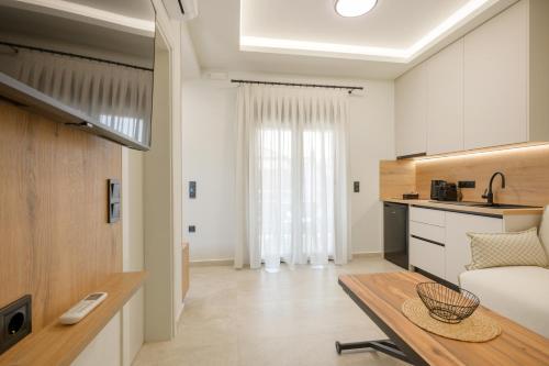 a kitchen and a living room with a table at Anesis Apartments in Ierissos