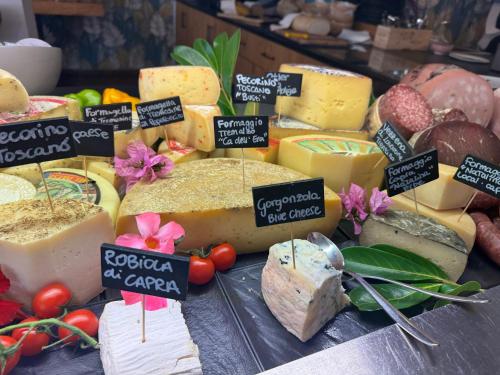 a display of different types of cheese on a table at Hotel Limone in Limone sul Garda
