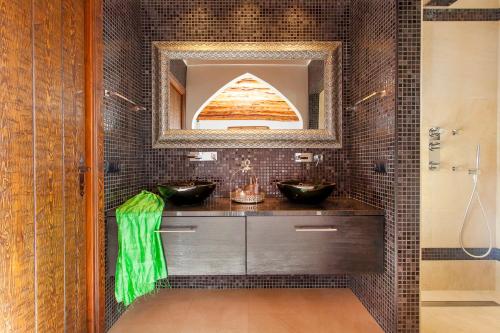 a bathroom with two sinks and a mirror at Villa Morna Valley in Sant Joan de Labritja