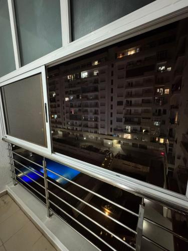 a window with a view of a city at night at Anis Home in Agadir