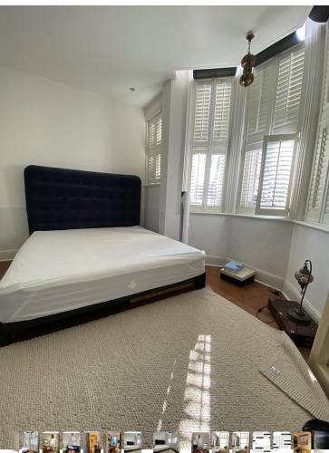 a bedroom with a bed in a room with windows at 600sf 1 bedroom apartment in Moffat