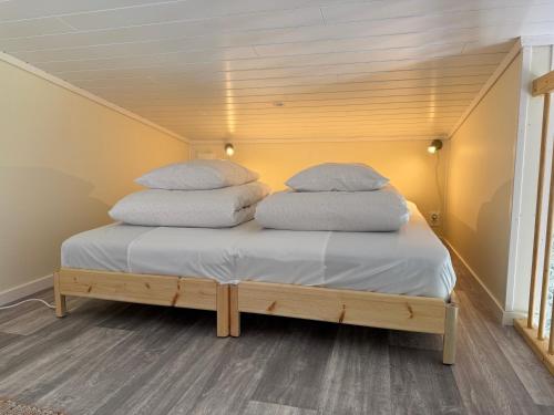 two pillows on top of a bed in a room at Flåm Tinyhouse with a Waterfall View in Flåm
