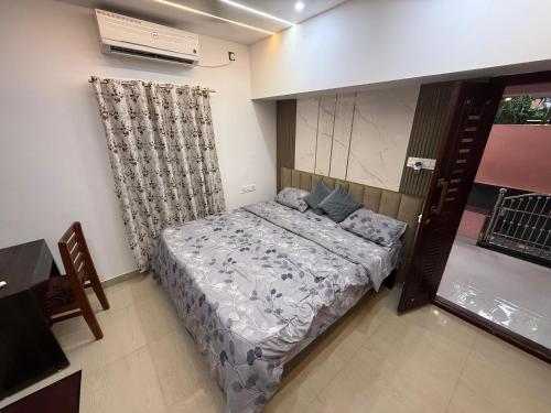 a small bedroom with a bed and a window at Tranquility Homestay in Varkala