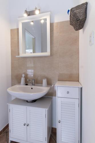 a bathroom with a sink and a mirror at Ecoappartment in Mosonmagyaróvár