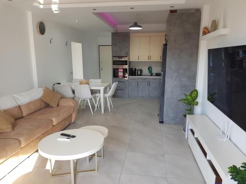 a living room with a couch and a table at South Coast Apartments AL2 in Sarandë
